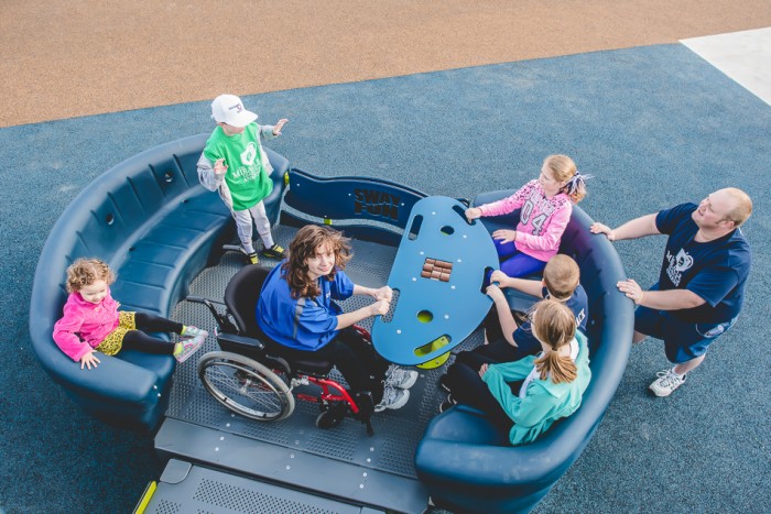 Inclusive playground equipment that fits wheelchair.